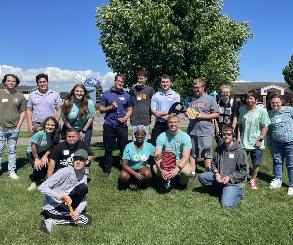 Michigan YPN Team in teal t-shirts with individuals from compassionate heart